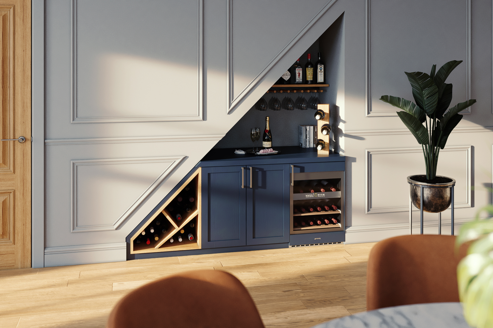 A compact wine bar under a staircase with blue cabinetry, wine racks, a mini fridge, and shelves for bottles and glasses.