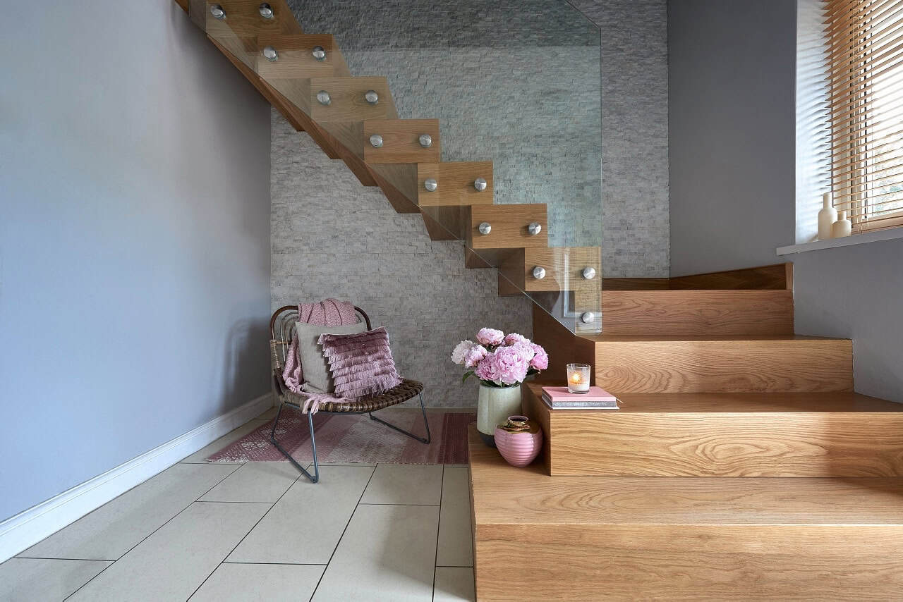 Modern stairway with decor and a cozy chair