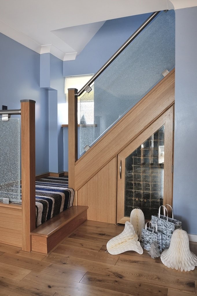 Image of a wood and glass Staircase with under-stair storage