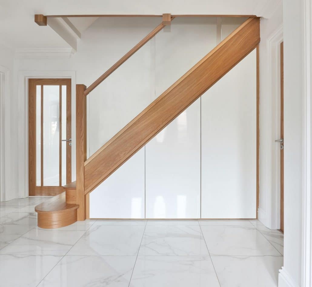 Modern staircase in a bright, minimalist hallway.